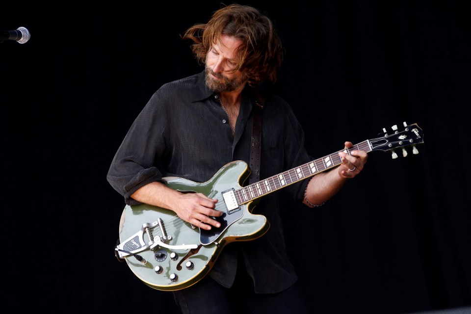 Actor Bradley Cooper playing the guitar at Glastonbury Festival in 2017