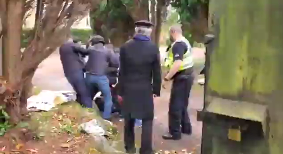 Video footage shows a man being held down and beaten