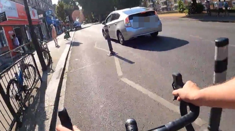 The driver is seen edging towards the kerb as the cyclist approaches