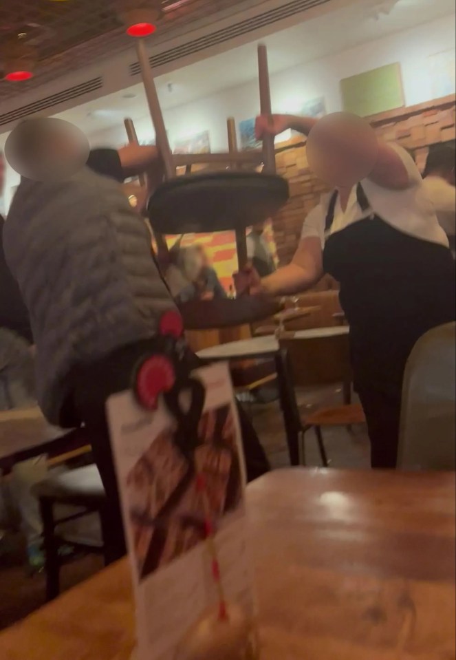 A scuffle broke out and two people were seen grappling with a chair