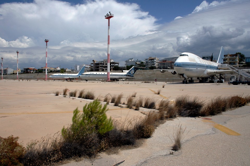 Abandoned planes from the defunct airline Olympic Airways remain parked at the airport