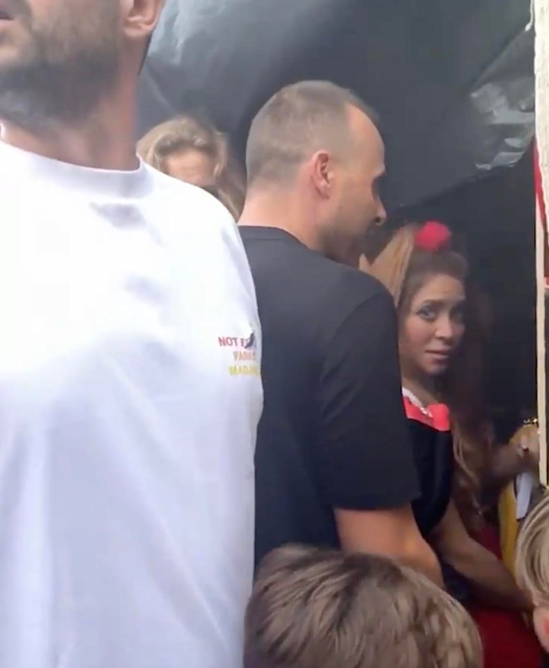 She was seen awkwardly glancing back at the crowd in Barcelona as she was ushered inside