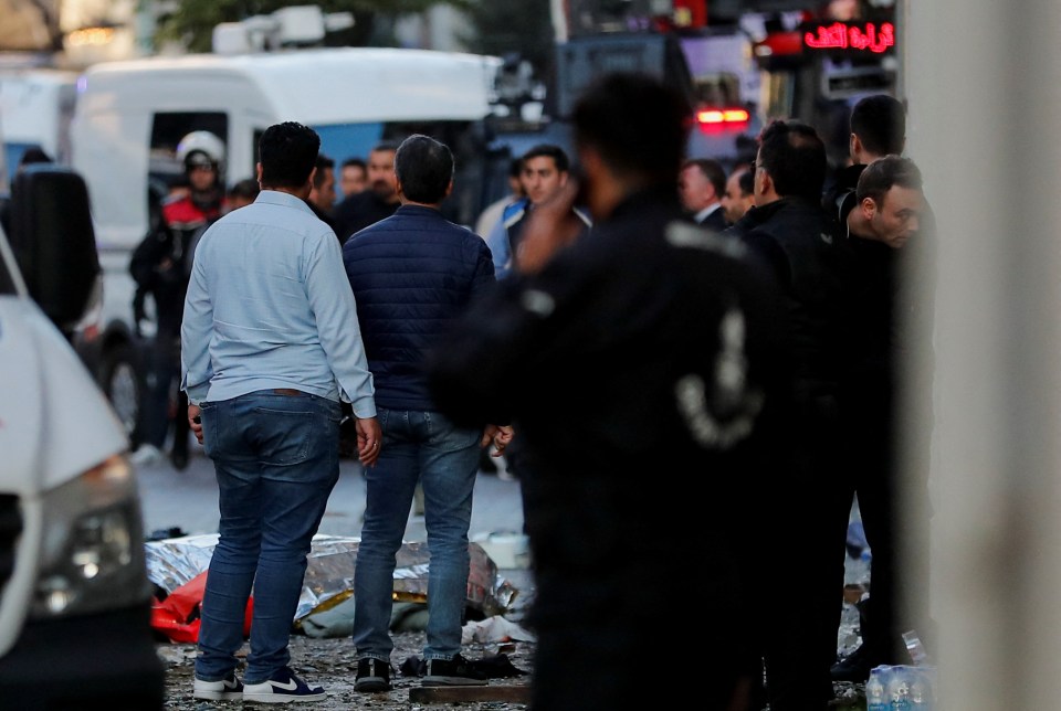 Bodies of unidentified people lay on the ground after the explosion