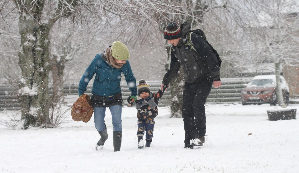 Mike and Amy Woolven with son Josh in the snow at Tomintoul today