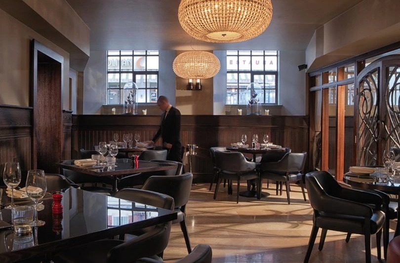 The brasserie-style restaurant has glitzy chandeliers, exposed brickwork and polished tables