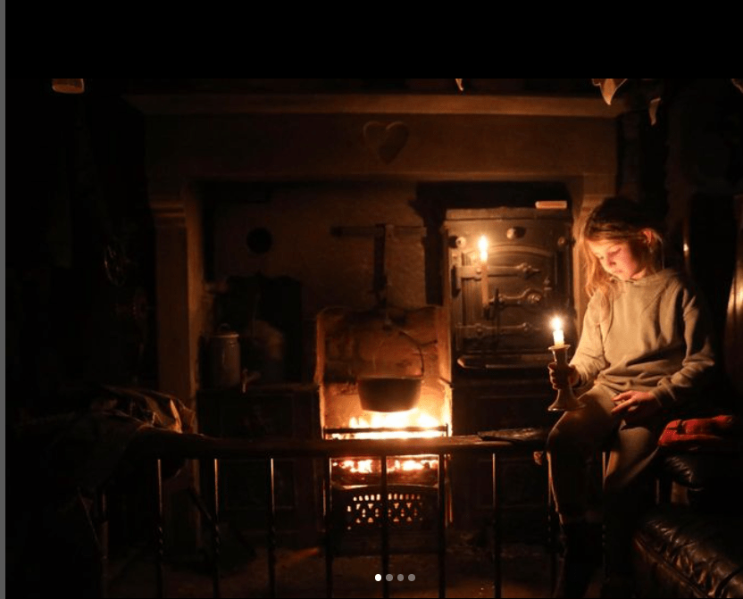 Amanda uploaded a photo of her one of her youngest daughters sitting by a candle light