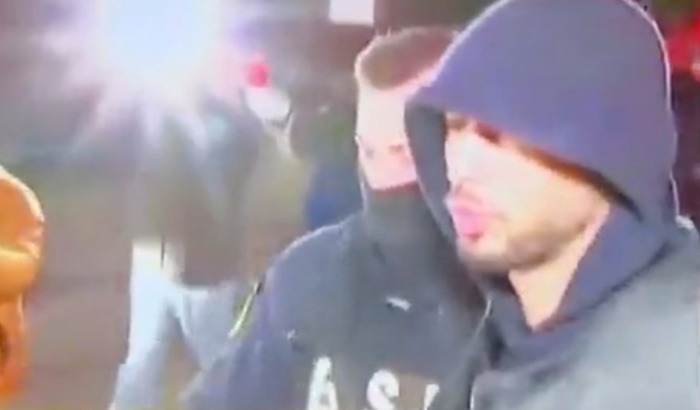 Tate had his hood up as he was led away