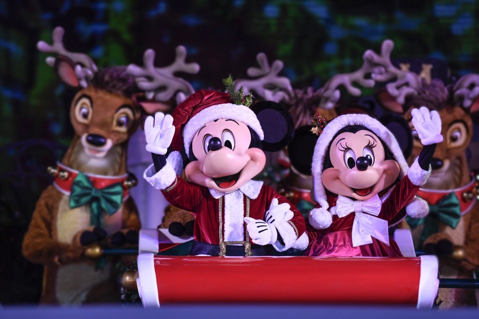 mickey mouse and minnie mouse are riding in a sleigh