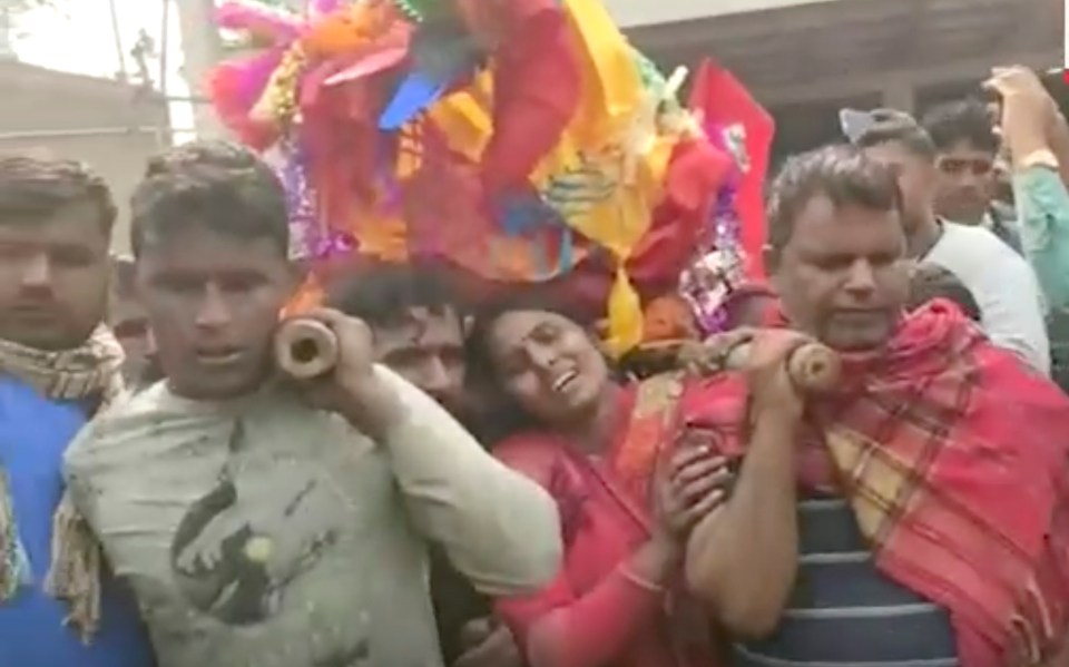 Families carry their dead loved ones after a mass death in India