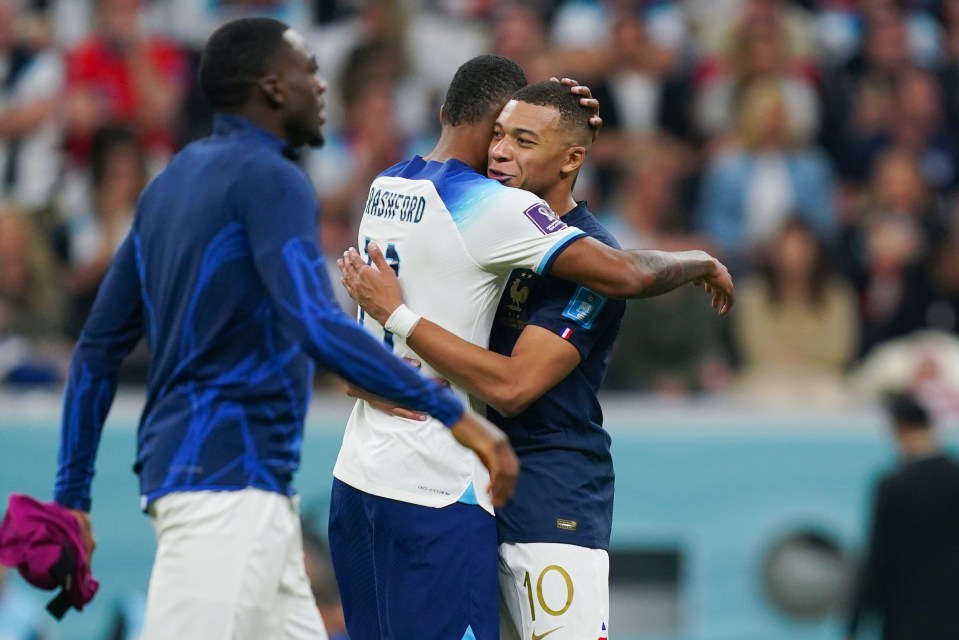 Marcus Rashford and Kylian Mbappe embrace each other after France's 2-1 win