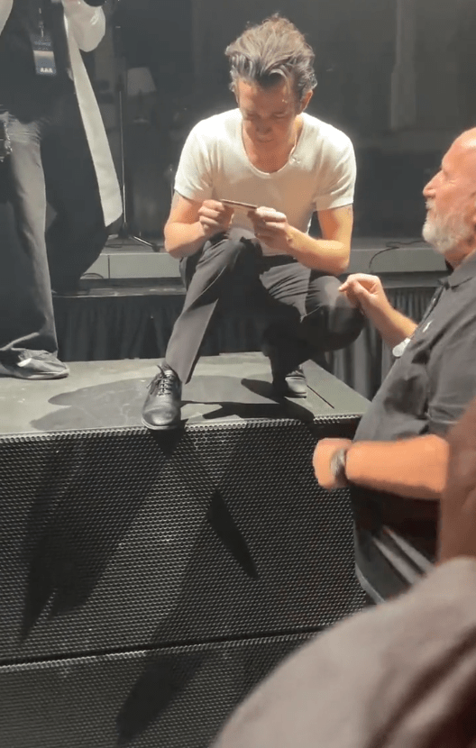 Footage shows Matt Healy appearing to check a woman's ID before kissing her
