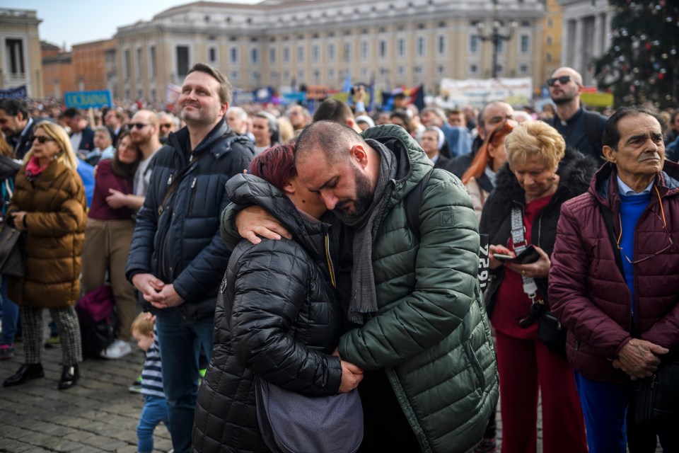 Mourners were pictured consoling each other as they paid their respects