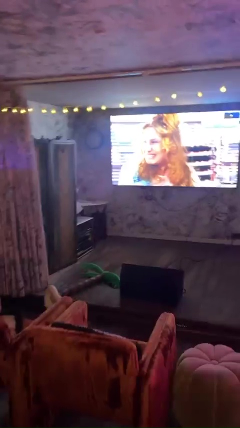 A room had been decked out with fairy lights and a huge TV screenm