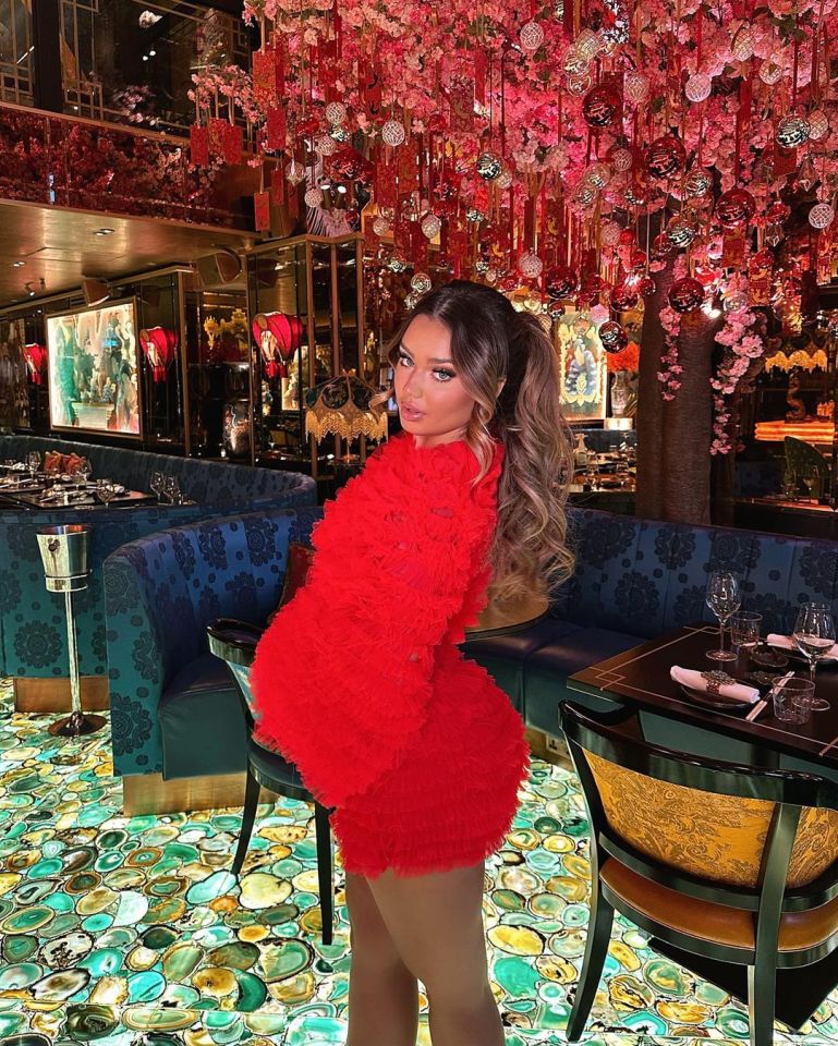 Lucinda Strafford addresses comments that she’s ‘pregnant’ as she poses in Red two piece