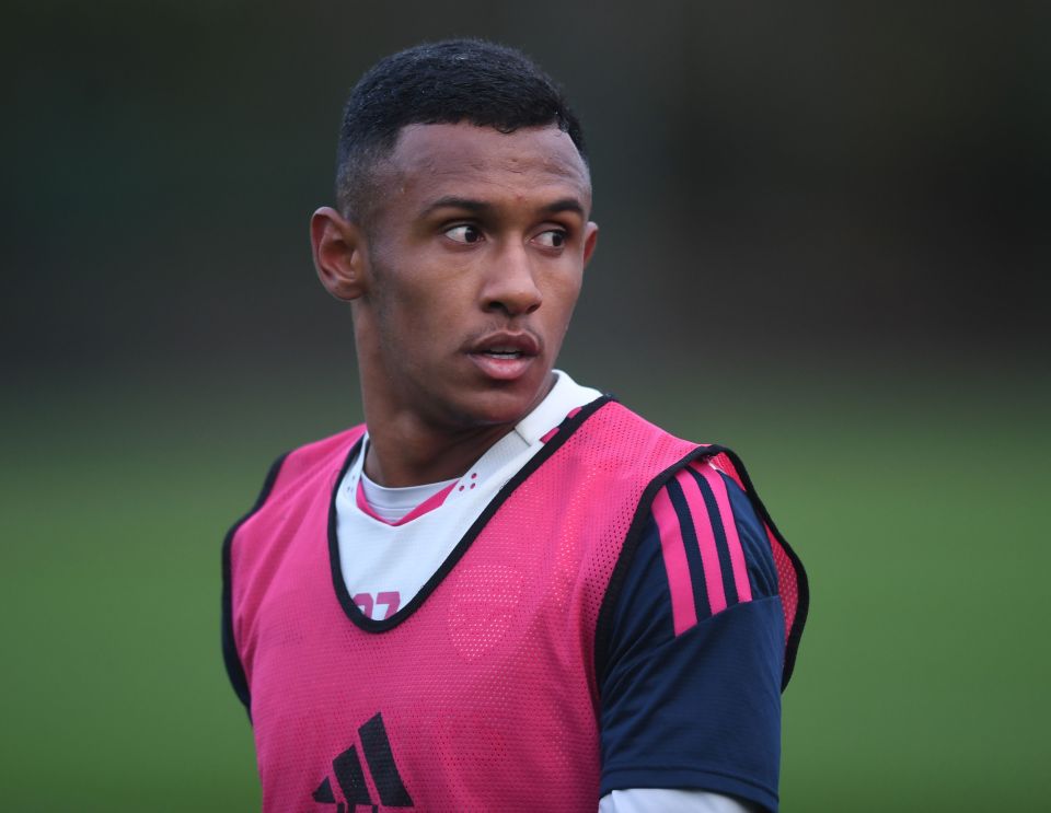 a soccer player wearing a pink adidas vest