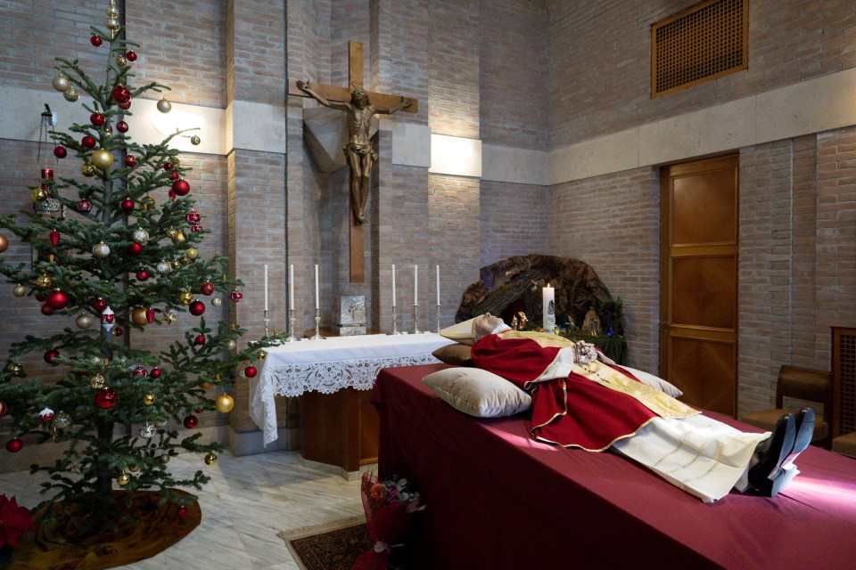 Benedict was pictured in the chapel clutching rosary beads