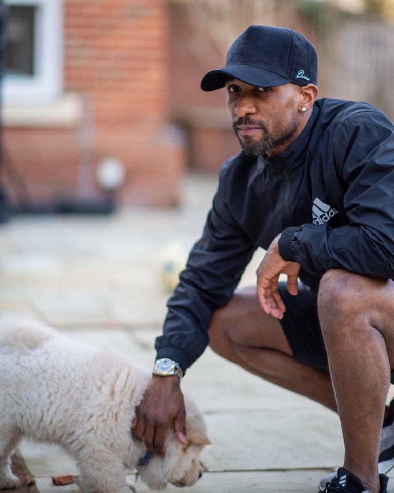 Snaps of telly pundit Defoe with the dog can still be seen on his public social media profile