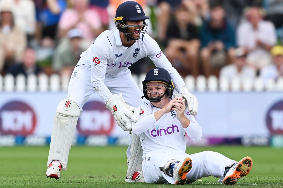 England wicketkeeper Ben Foakes embraces teammate Ollie Pope after his catch to dismiss New Zealand’s Henry Nicholls
