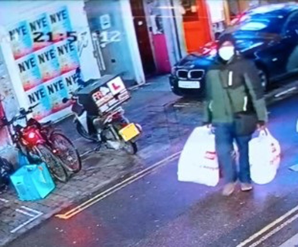 Mark Gordon with Argos bags believed to contain camping gear on Brick Lane in London
