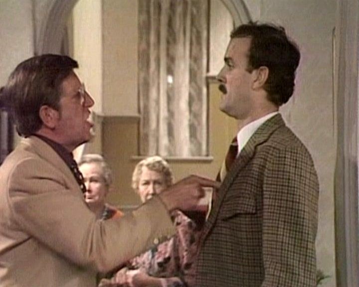 Basil argues with an American guest over a Waldorf salad request