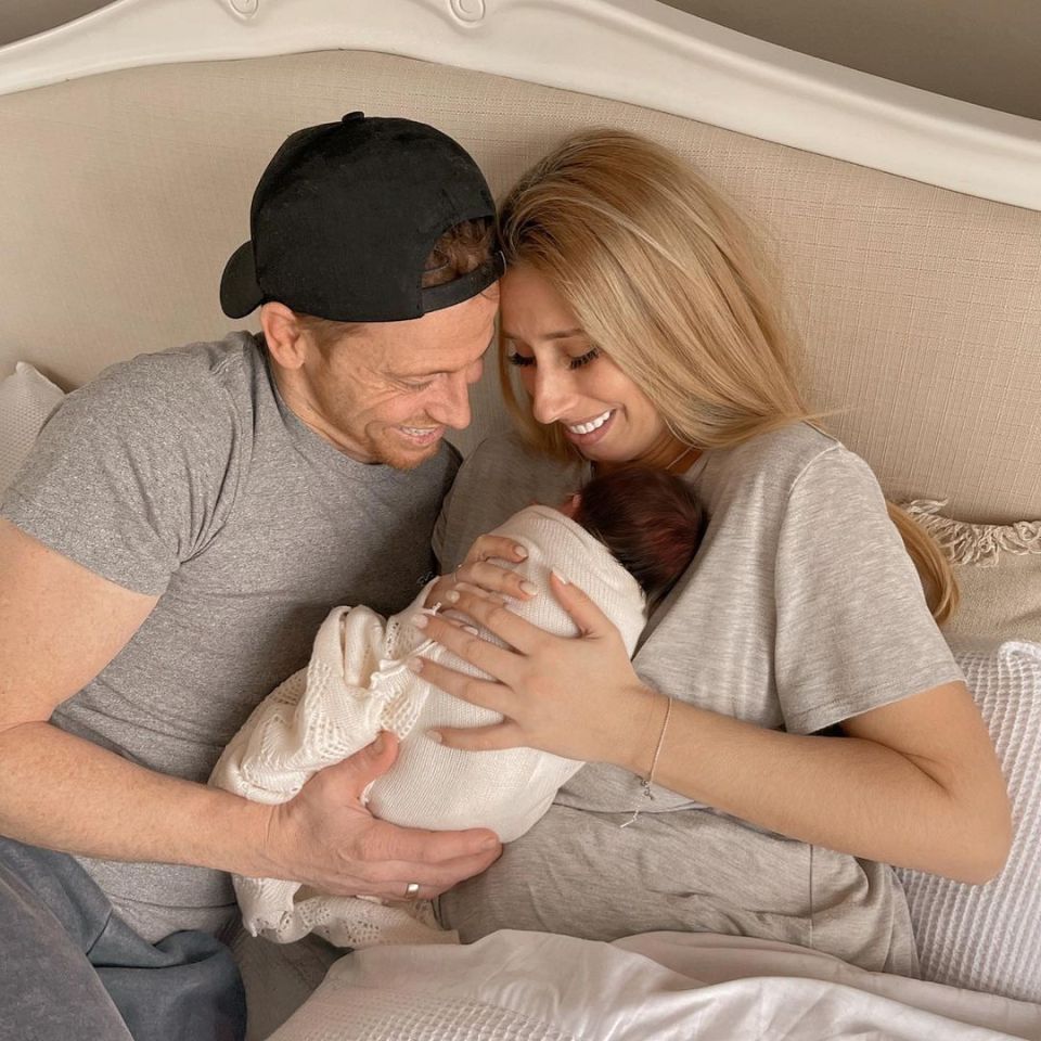 Parents holding their newborn baby.