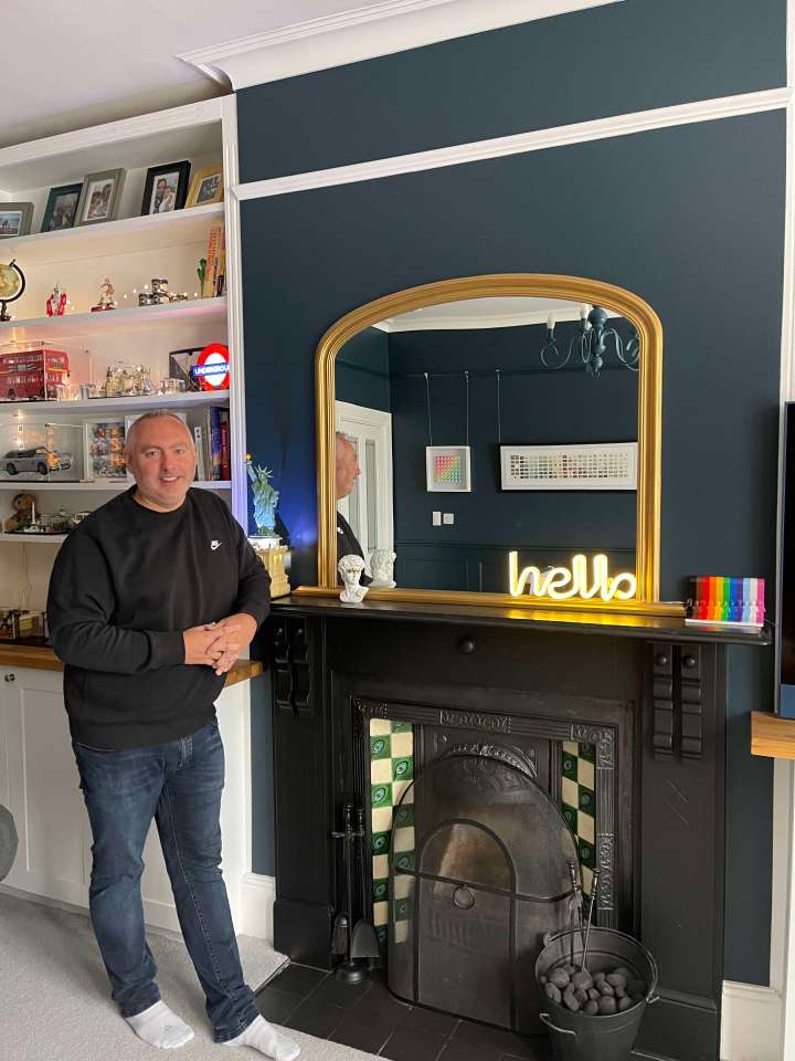 Mike standing by the fireplace in the living room which was one of the potential hazards that led to the renovation