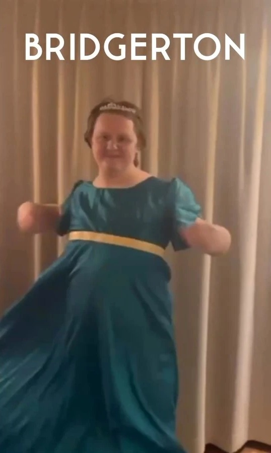 To celebrate the news, he wore a blue dress and tiara like the women of Bridgerton