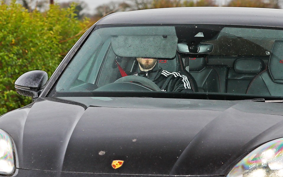 David De Gea shielded his face as he arrived at training