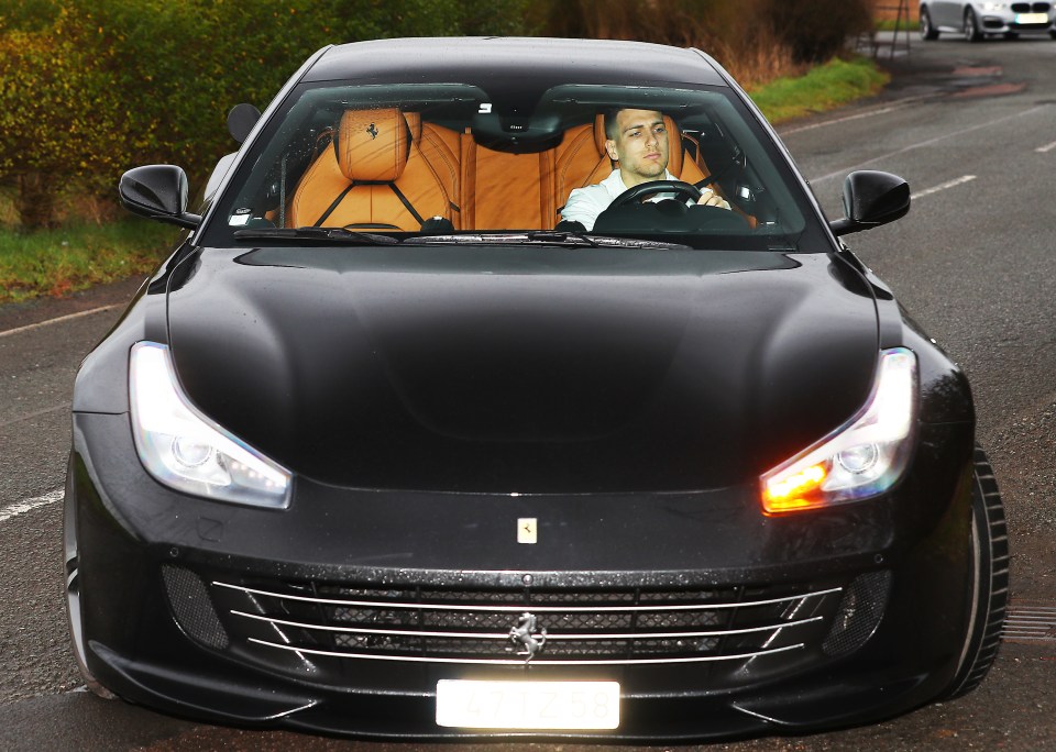 Diogo Dalot pictured behind the wheel of his Ferrari as he reported for duty