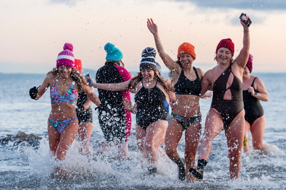 The women hit the waves first thing this morning despite the freezing temperatures