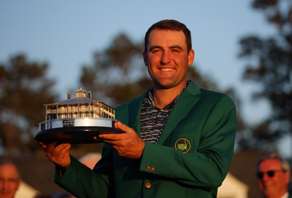 Scottie Scheffler holds the championship trophy after winning the 86th Masters