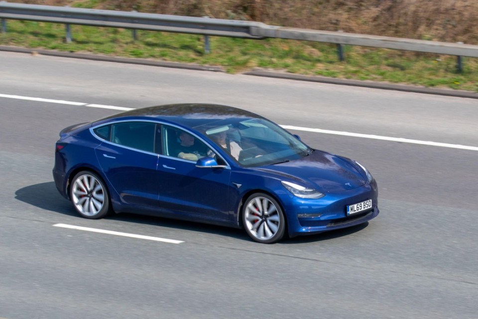 2J1WE4K 2019 Tesla Model 3 Performance AWD All Models; driving on the M61 near Manchester, UK
