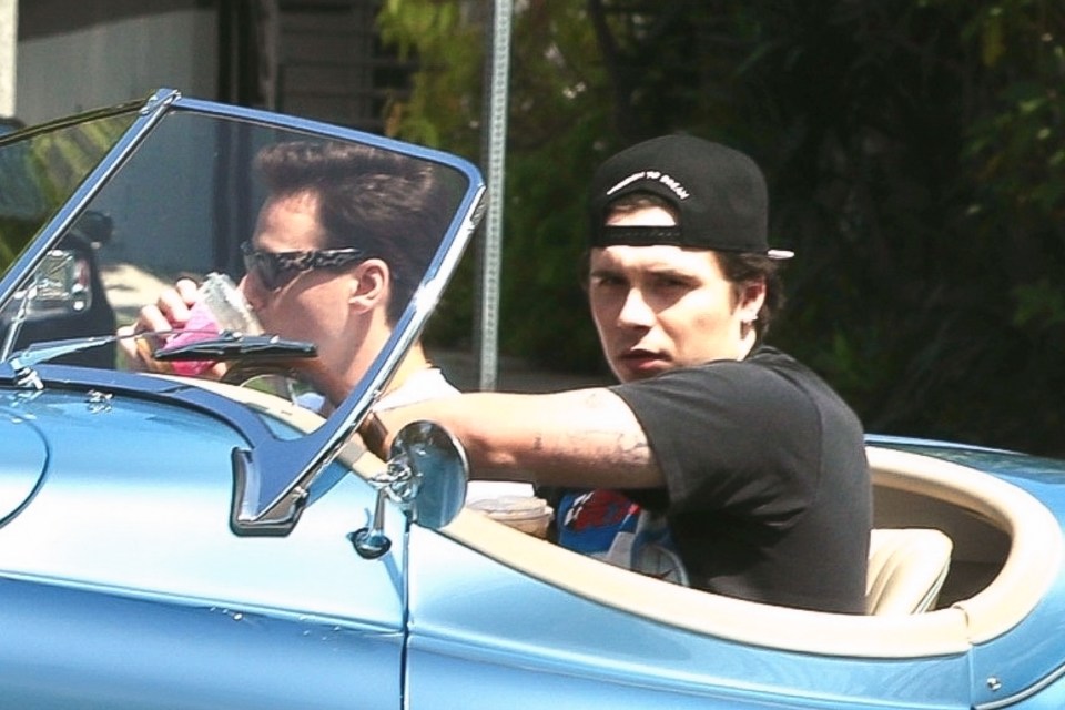 BGUK_2623454 - Los Angeles, CA - *EXCLUSIVE* - Brooklyn Beckham goes for a ride with a friend on his $500k blue vintage electric Jaguar. Pictured: Brooklyn Beckham BACKGRID UK 25 APRIL 2023 UK: +44 208 344 2007 / uksales@backgrid.com USA: +1 310 798 9111 / usasales@backgrid.com *UK Clients - Pictures Containing Children Please Pixelate Face Prior To Publication*