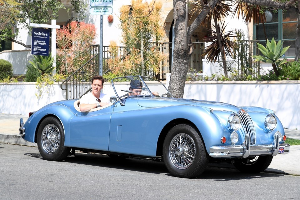 BGUK_2623454 - Los Angeles, CA - *EXCLUSIVE* - Brooklyn Beckham goes for a ride with a friend on his $500k blue vintage electric Jaguar. Pictured: Brooklyn Beckham BACKGRID UK 25 APRIL 2023 UK: +44 208 344 2007 / uksales@backgrid.com USA: +1 310 798 9111 / usasales@backgrid.com *UK Clients - Pictures Containing Children Please Pixelate Face Prior To Publication*