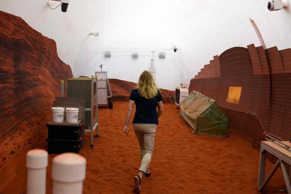 Dr. Suzanne Bell, Lead for NASA's Behavioral Health and Performance Laboratory, walks through a simulated Mars exterior portion of the CHAPEA's Mars Dune Alpha at the Johnson Space center in Houston, Texas on April 11, 2023. - CHAPEA's Mars Dune Alpha is a 3D printed habitat designed to serve as an analog for one-year missions (Photo by Mark Felix / AFP) (Photo by MARK FELIX/AFP /AFP via Getty Images)