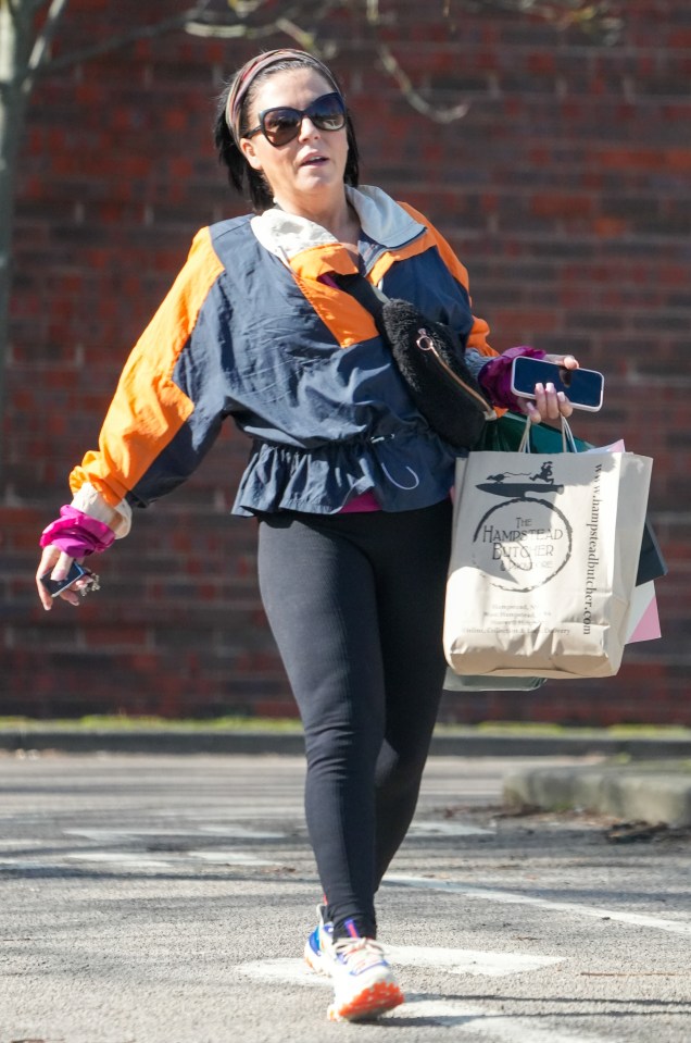 EXCLUSIVE: Eastenders star Jessie Wallace is seen without an engagement ring as she was seen in North London...Wallace, 51, celebrated her engagement to partner Justin Gallwey back in February this year, but there was no ring in sight as she ran some errands alone...The actress was seen sporting a new bobbed hairstyle and rocking a '90s look in an orange shell suit top matched with a headband as she loaded her car with groceries in North London.....Pictured: Jessie Wallace..Ref: SPL5532950 270323 EXCLUSIVE..Picture by: SplashNews.com....Splash News and Pictures..USA: +1 310-525-5808.London: +44 (0)20 8126 1009.Berlin: +49 175 3764 166..photodesk@splashnews.com....World Rights, No France Rights..