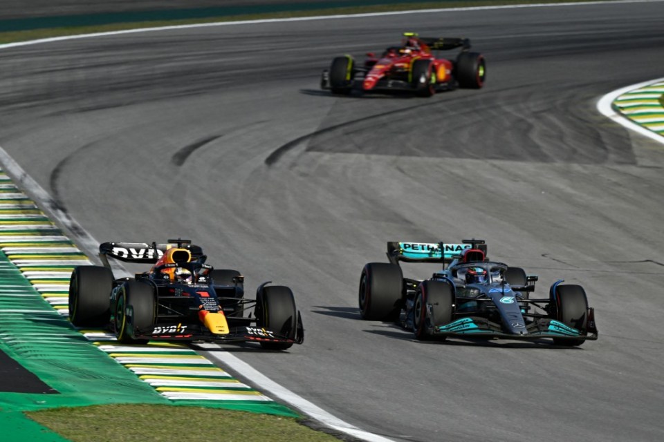 Red Bull Racing's Dutch driver Max Verstappen (L) and Mercedes' British driver George Russell (R) race during the sprint qualifying at the Autodromo Jose Carlos Pace racetrack, also known as Interlagos, in Sao Paulo, Brazil, on November 12, 2022, ahead of the Formula One Brazil Grand Prix. (Photo by MAURO PIMENTEL / AFP) (Photo by MAURO PIMENTEL/AFP via Getty Images)