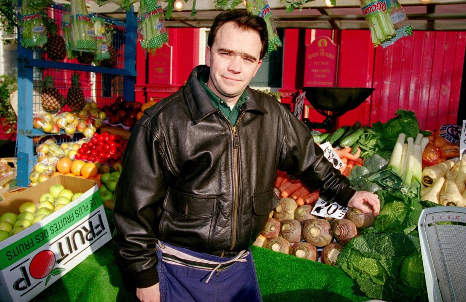 Todd Carty as Mark Fowler at a fruit and vegetable stall.