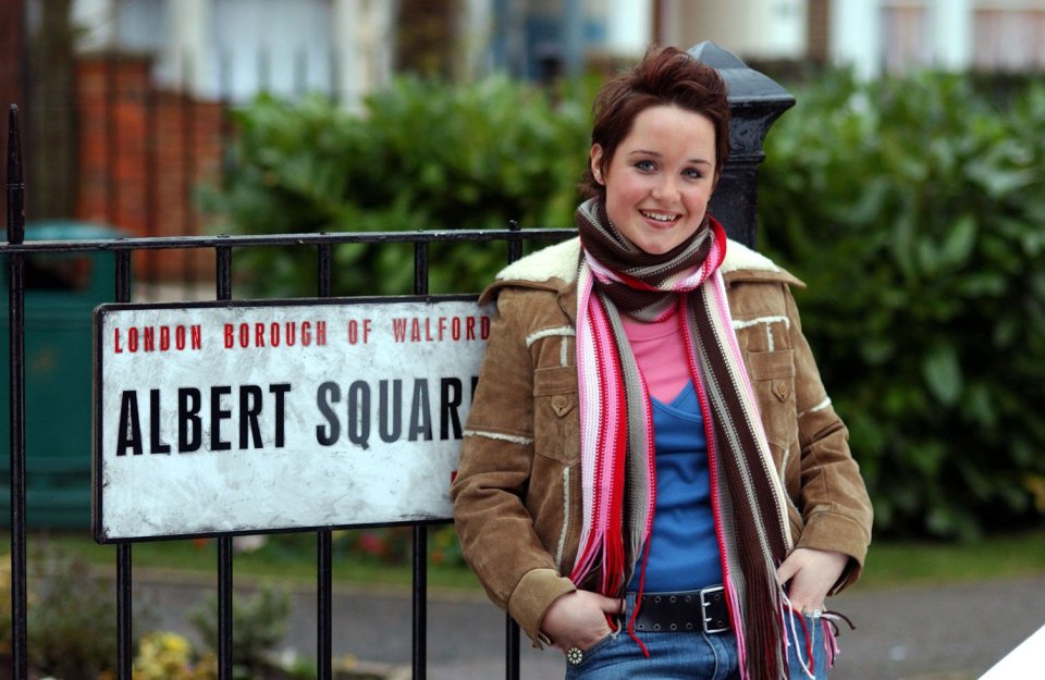 Scarlett Johnson as Vicki Fowler in EastEnders, standing by an Albert Square street sign.