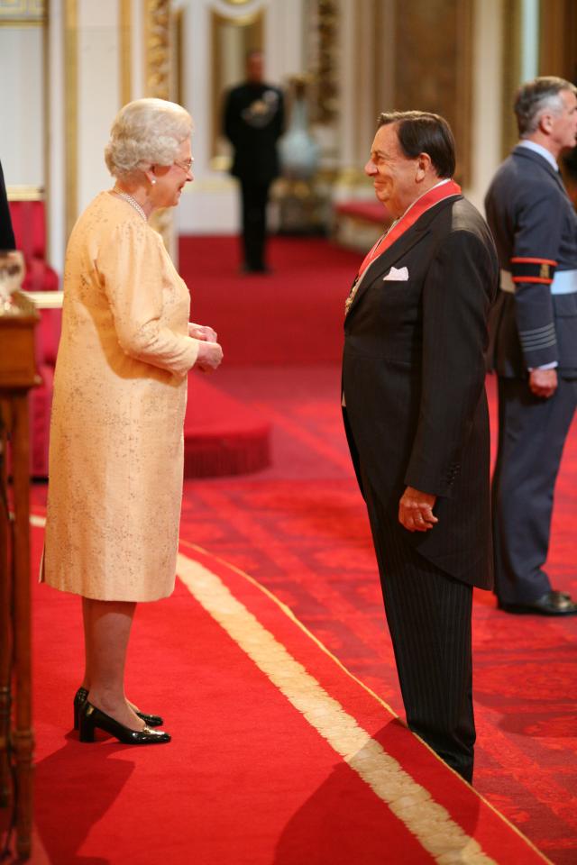 Humphries receiving a CBE from the late Queen