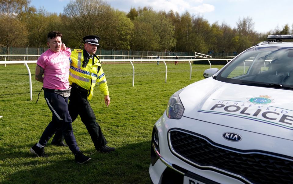 Protesters are detained by police during day three of the Randox Grand National Festival at Aintree Racecourse, Liverpool