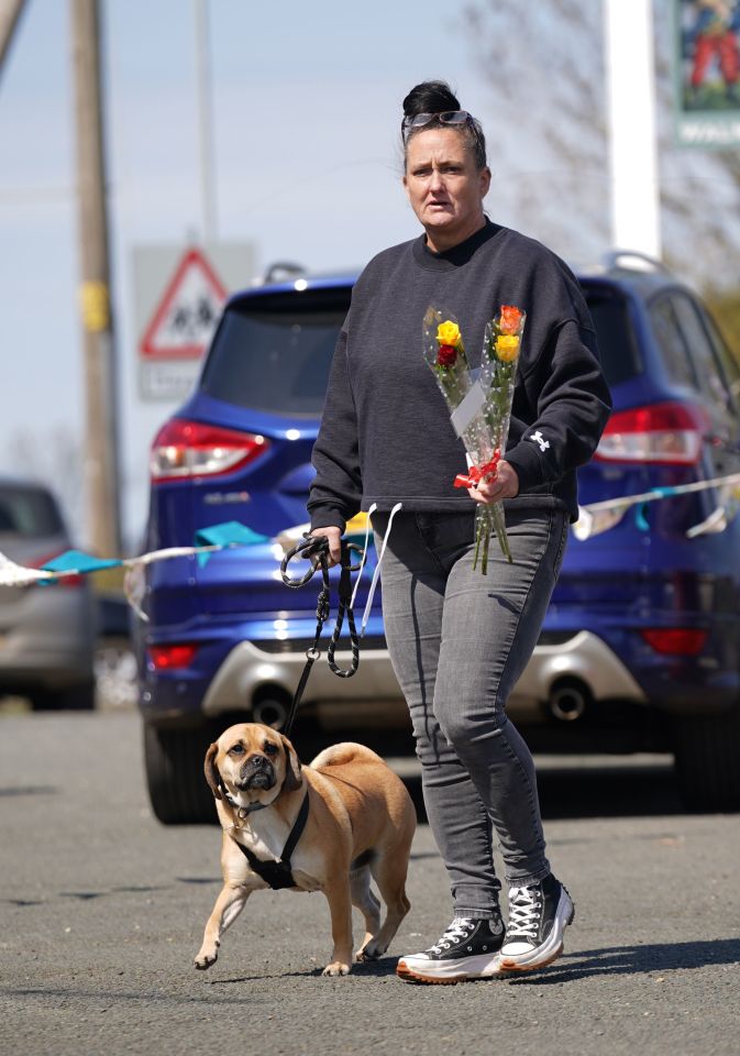 Many mourners had flowers in hand as they made their way to join the masses on the streets