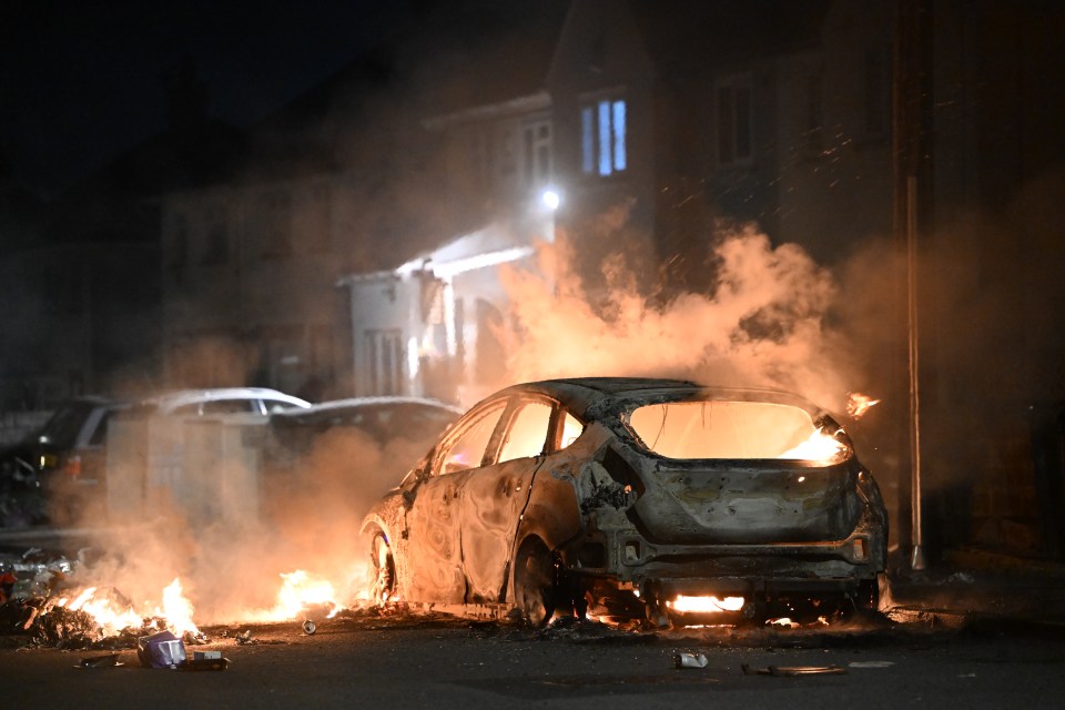 The unrest left cars torched and a dozen cops injured