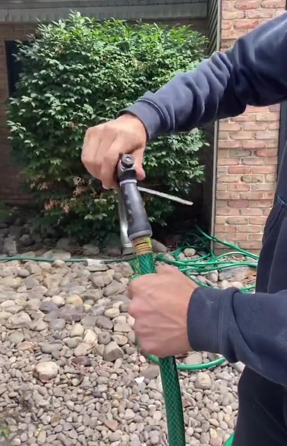 He then screws the nozzle back on