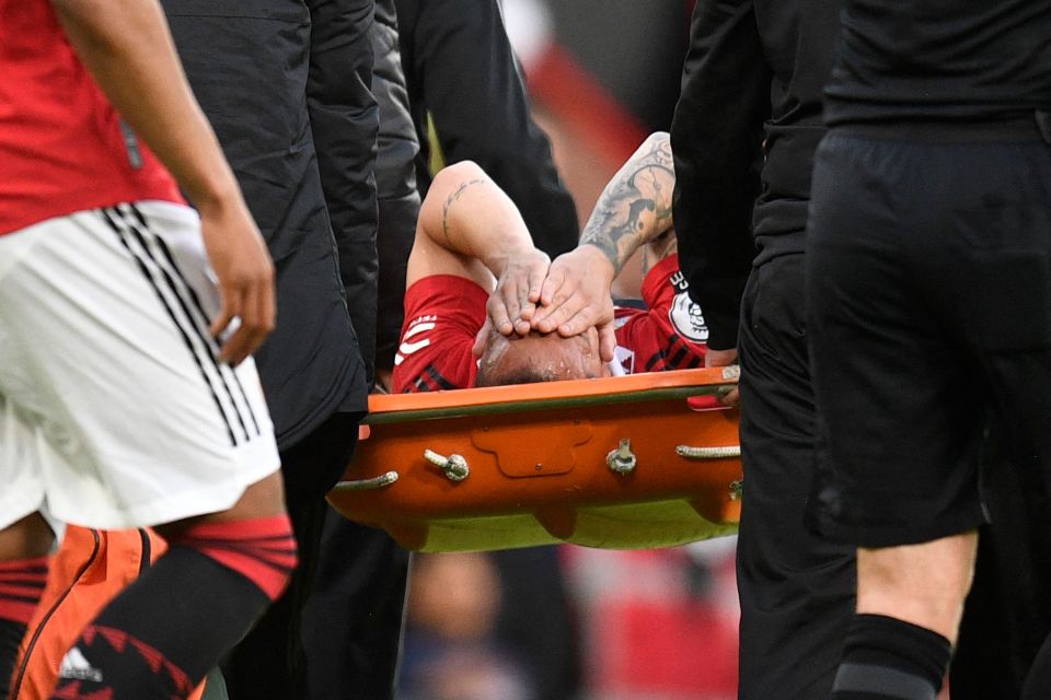 The winger covered his face as he was stretchered off