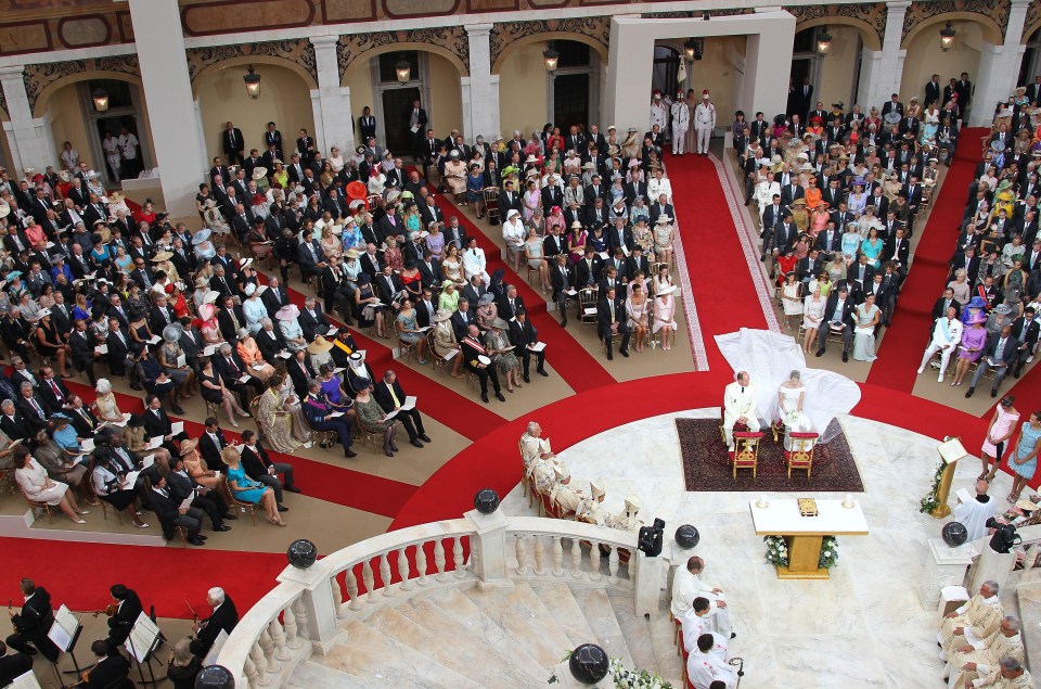 Prince Albert and Princess Charlene of Monaco sit in front of the altar during their religious wedding at the Main Courtyard
