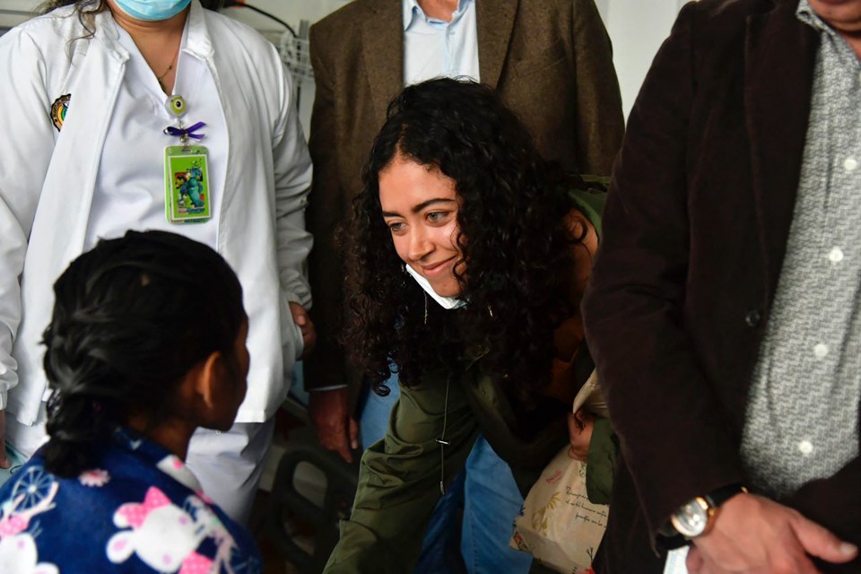 Sofia Petro, daughter of Colombian President Gustavo Petro, centre, greeting Lesly, left
