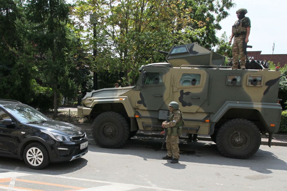Members of Wagner group stand guard in a street in the city of Rostov