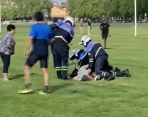Footage shows the cops tackling a man to the ground