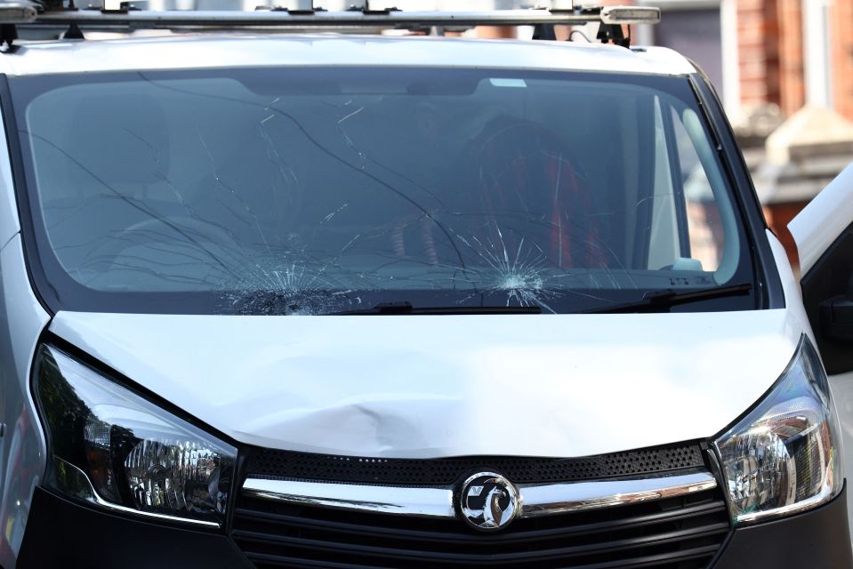 Damage is seen to the front of a white van